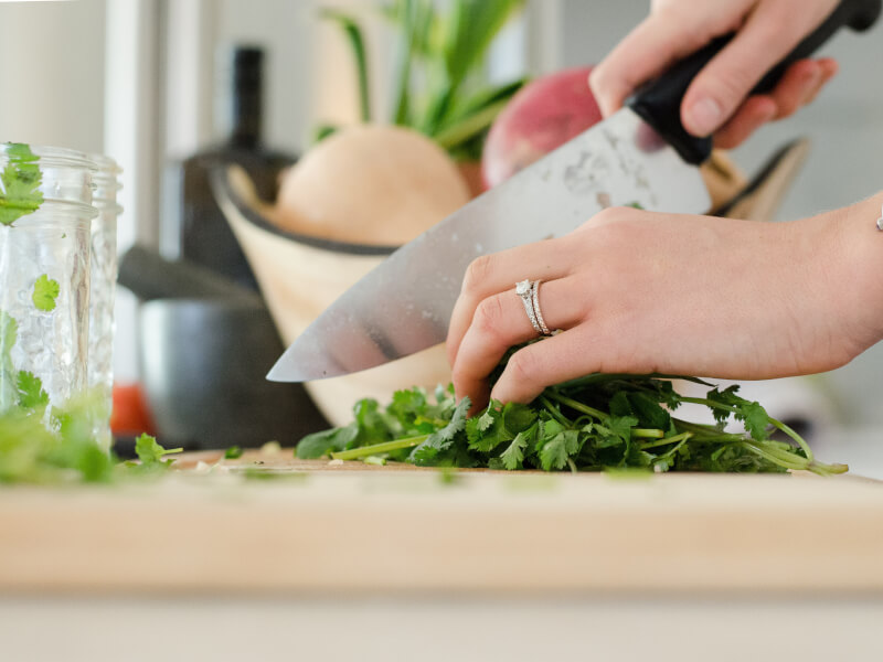 A person chopping vegetables